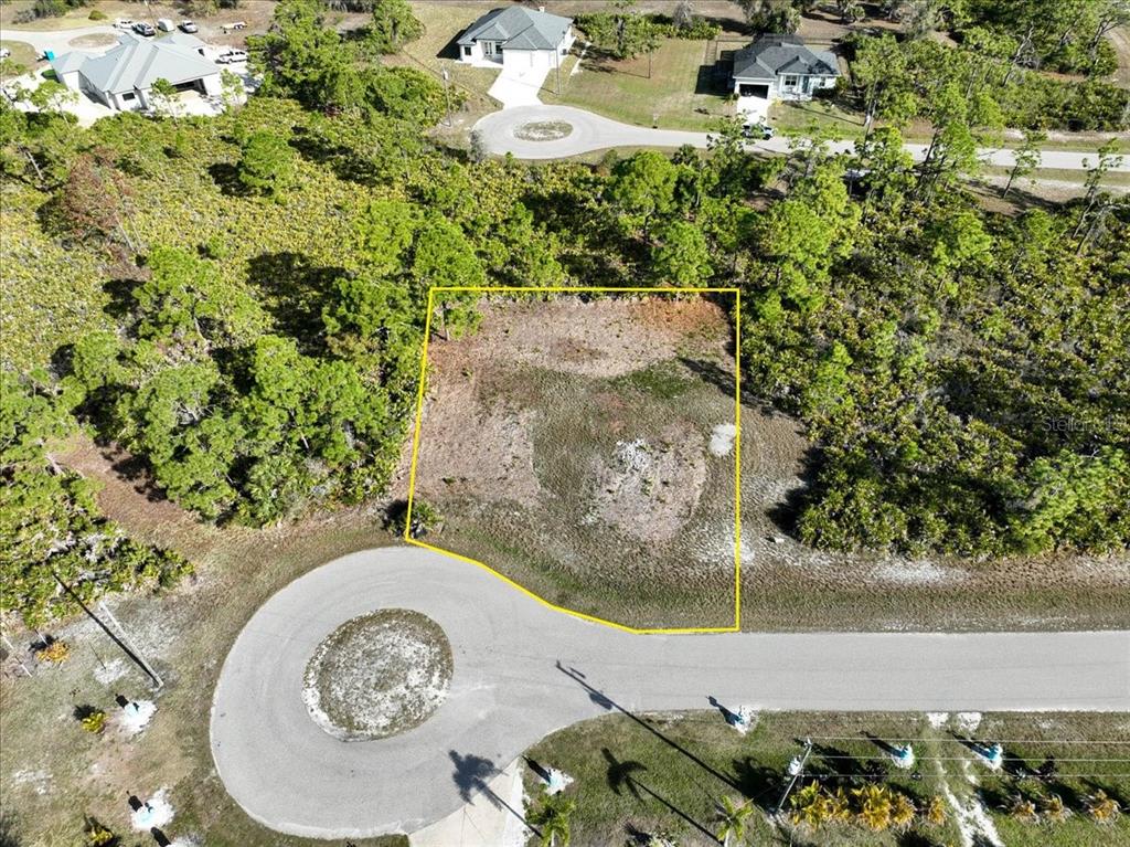 An aerial view shows a vacant, rectangular residential lot outlined in yellow along a cul-de-sac — 6 BERTH COURT, PLACIDA, FL