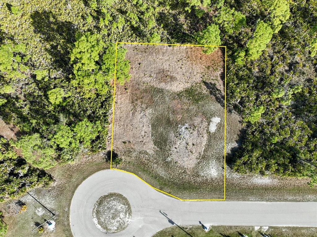 An aerial view shows a vacant, rectangular residential lot outlined in yellow along a cul-de-sac — 6 BERTH COURT, PLACIDA, FL
