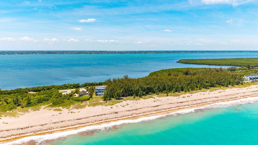 An aerial view shows a vacant, trapezoidal lot situated between a road and the ocean — 0 S Ocean Drive, Fort Pierce FL, FORT PIERCE, FL