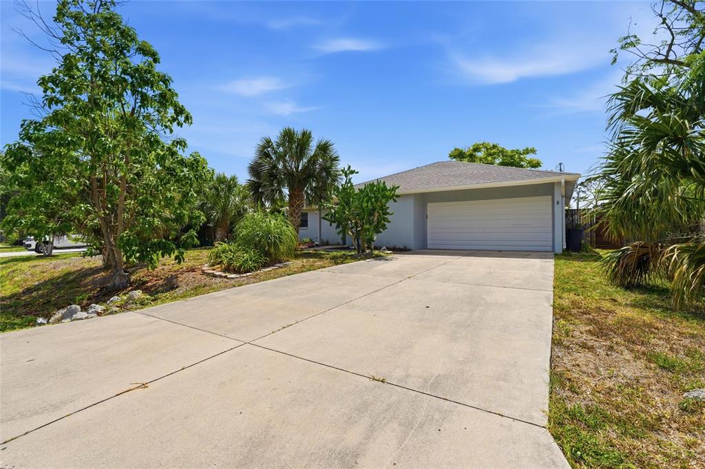 A single-story house with a white garage door and a concrete driveway — 1163 RINGTAIL ROAD, VENICE, FL