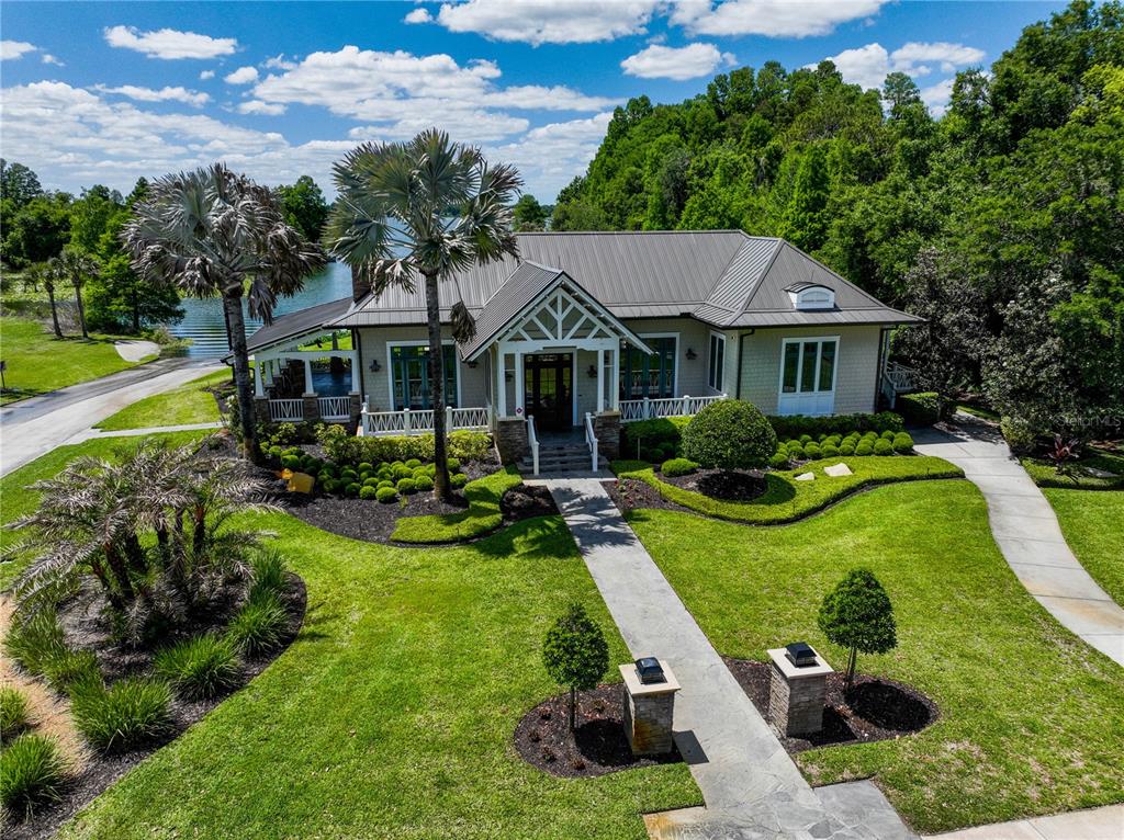 An aerial view of a single-story house with a metal roof and landscaped front yard — 12322 STONELAKE RANCH BOULEVARD, THONOTOSASSA, FL