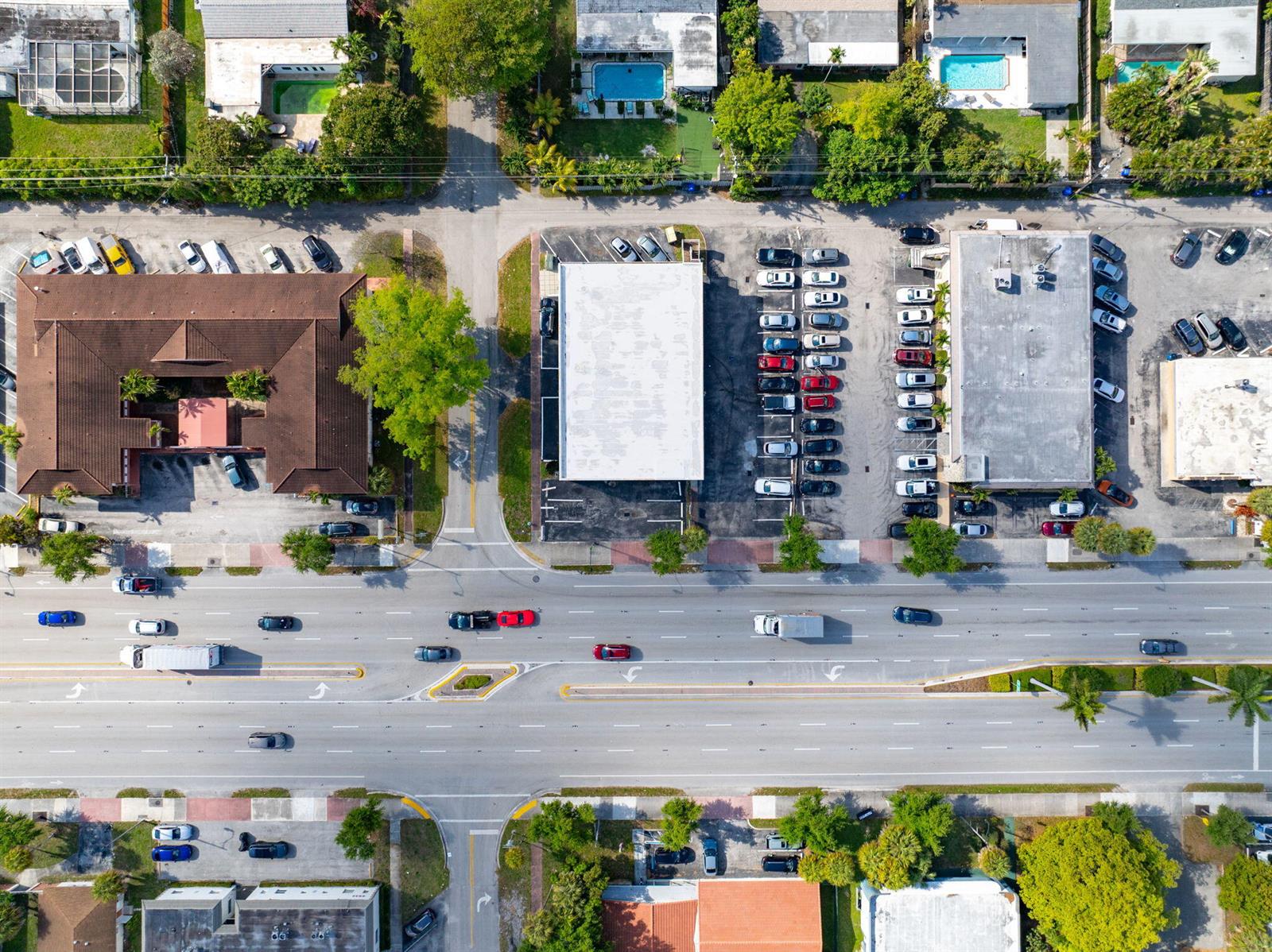 An aerial view shows commercial buildings, parking lots, and a multi-lane road with traffic — 5000 Hollywood Boulevard, Hollywood FL 33021, HOLLYWOOD, FL