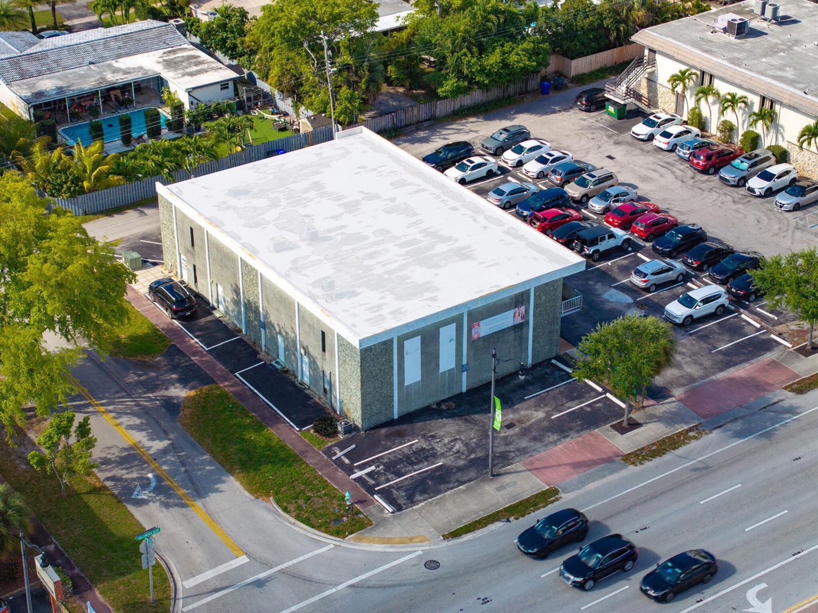 An aerial view shows a commercial building with a flat roof and a parking lot — 5000 Hollywood Boulevard, Hollywood FL 33021, HOLLYWOOD, FL