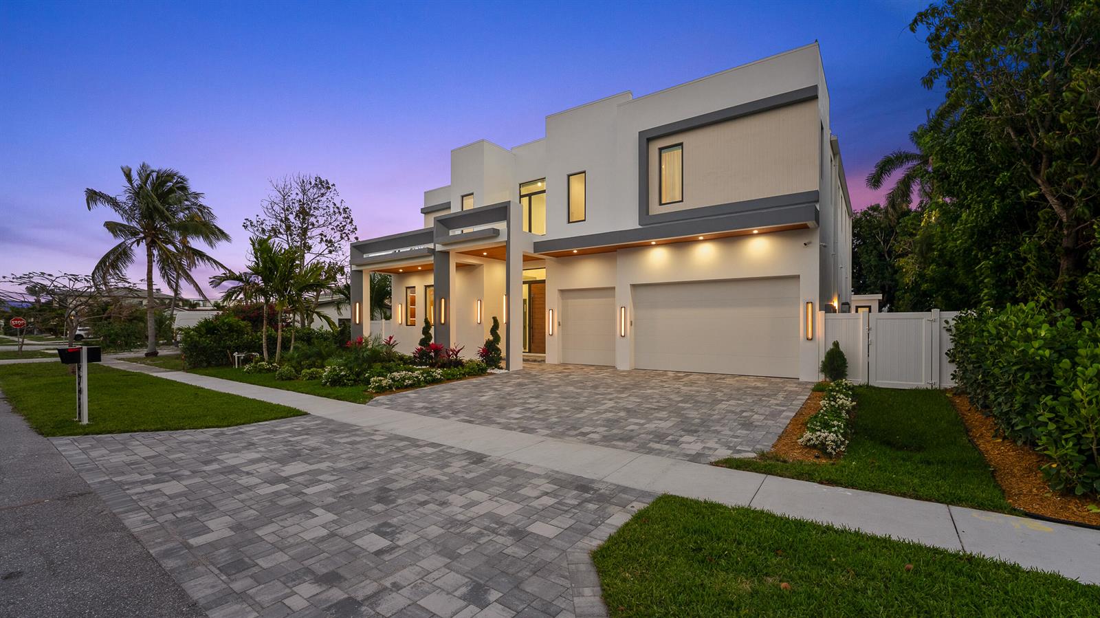 A modern two-story house with a paved driveway, two-car garage, and exterior landscape lighting — 274 NE 3rd Court, Boca Raton FL 33432, BOCA RATON, FL