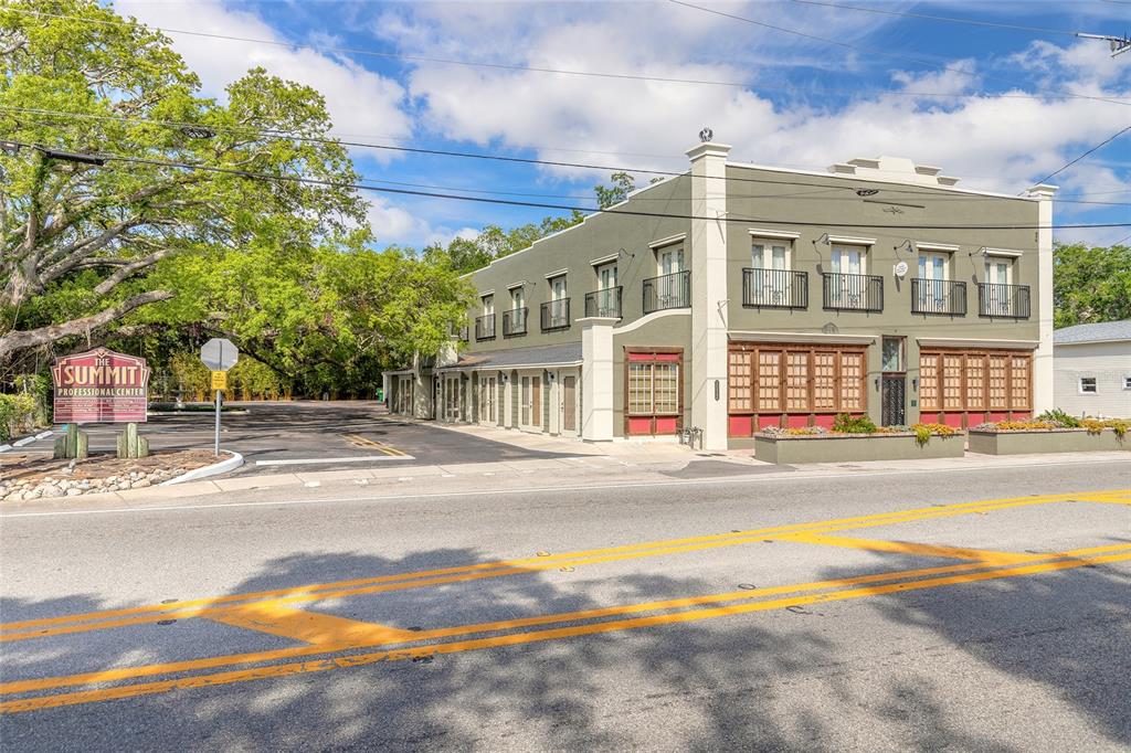 A two-story olive-green commercial building with a parking lot and large trees — 1112 RIVERSIDE DRIVE, DAYTONA BEACH, FL
