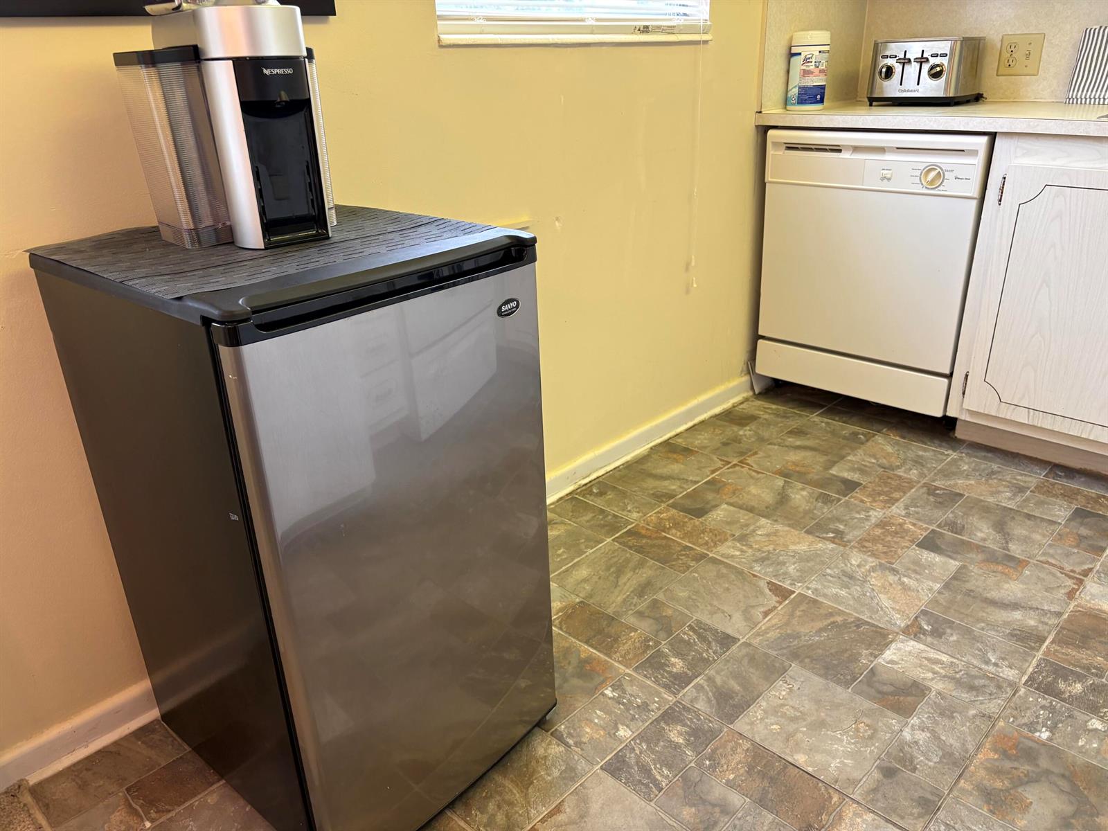 A small refrigerator with a coffee machine sits in a kitchen with tile flooring — 112 Preston Way # C, Boca Raton FL 33434, BOCA RATON, FL
