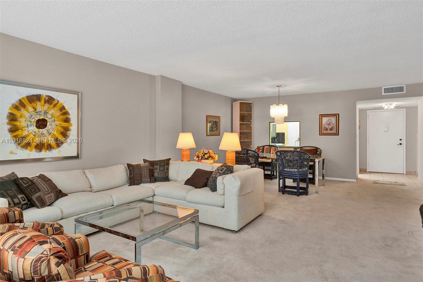 A living and dining room area features a white sectional sofa, glass coffee table, and carpet — 1865 S Ocean Dr # 4C, Hallandale Beach FL 33009, HALLANDALE BEACH, FL