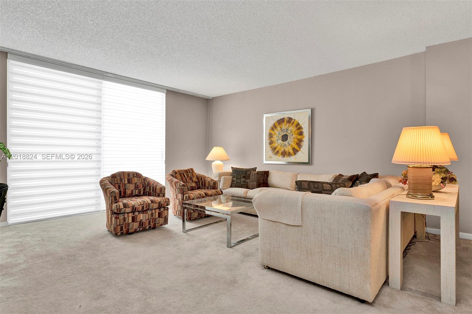 A living room features a beige sofa, two patterned armchairs, and a glass coffee table — 1865 S Ocean Dr # 4C, Hallandale Beach FL 33009, HALLANDALE BEACH, FL