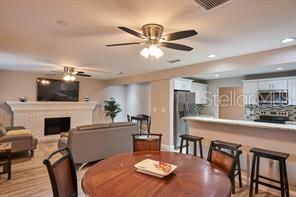 A long hallway with light wood-look flooring leads to a doorway at the far end — 4433 W OKLAHOMA AVENUE, TAMPA, FL