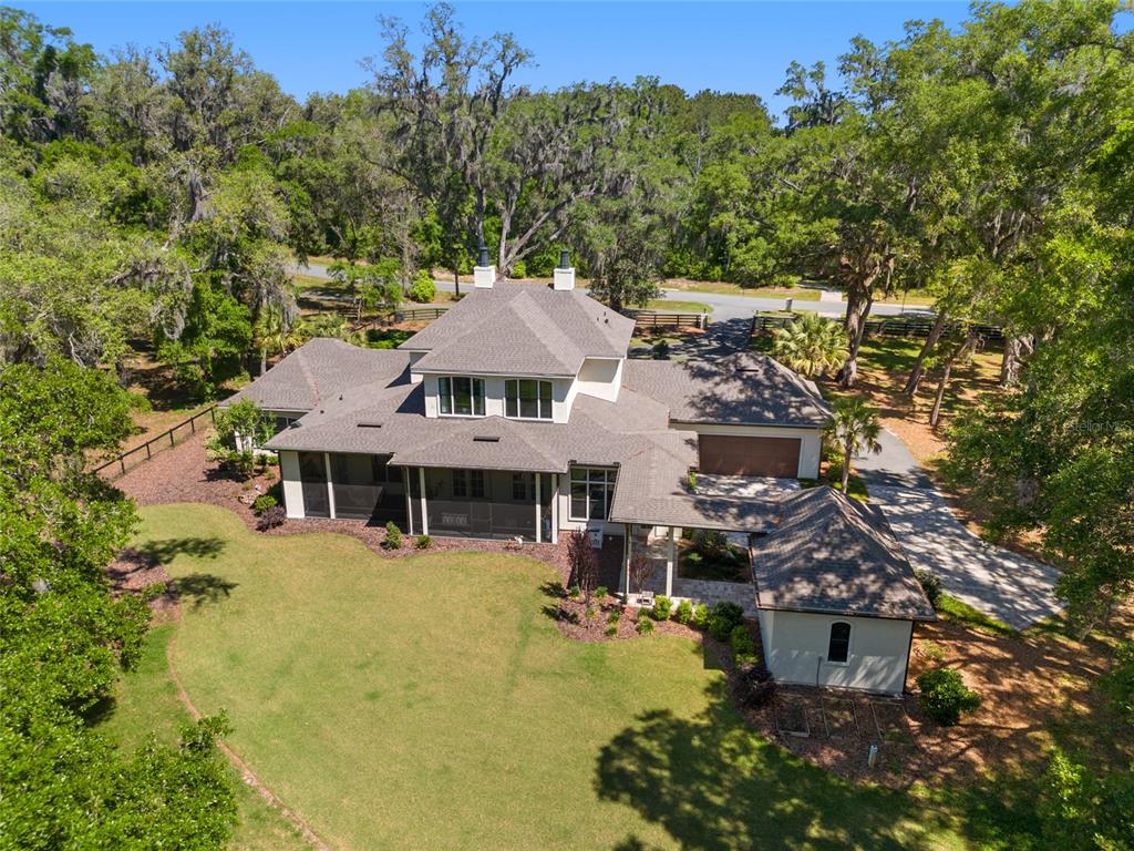 An aerial view shows a multi-story house with a screened porch and detached garage — 14819 NW 21ST AVENUE, NEWBERRY, FL