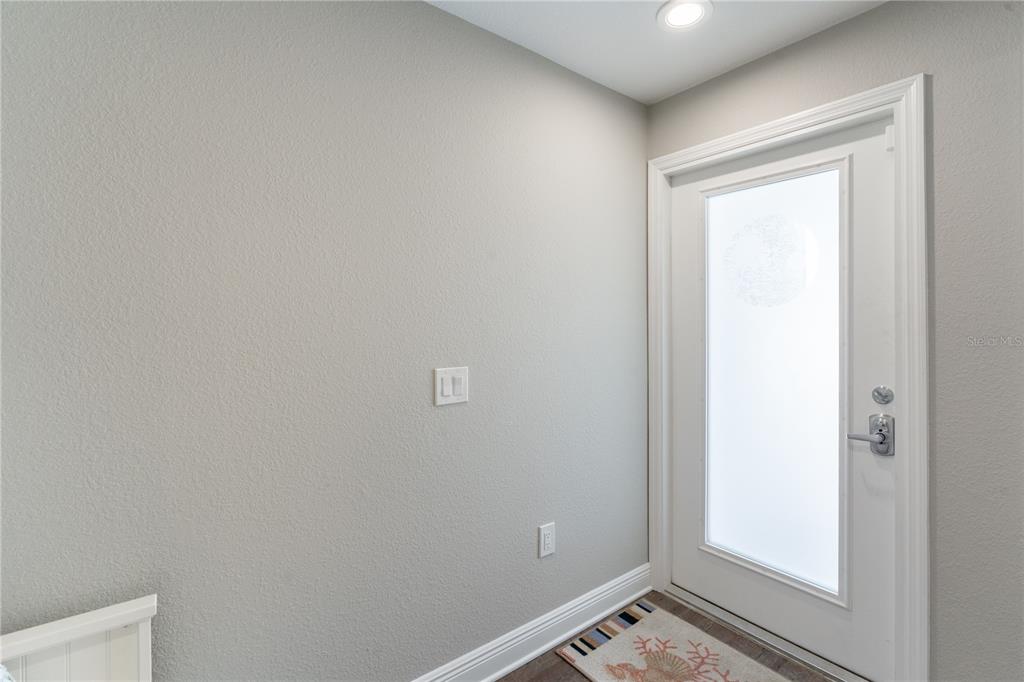 A light gray entryway features a white door with a frosted glass panel — 2255 N BEACH ROAD UNIT 12, ENGLEWOOD, FL