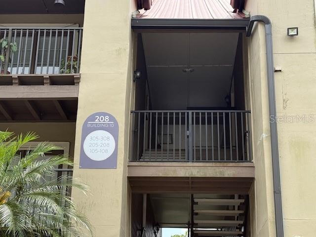 An exterior view of a multi-story apartment building with a metal staircase and balcony — 208 AFTON SQUARE UNIT 10-307, ALTAMONTE SPRINGS, FL