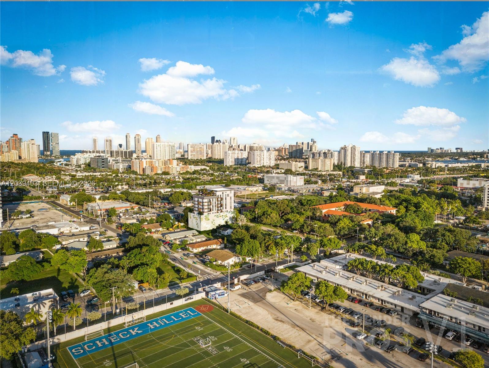 This is an aerial view of a school sports field and surrounding neighborhood buildings — 2557 NE 190th st # 506, Miami FL 33180, MIAMI, FL