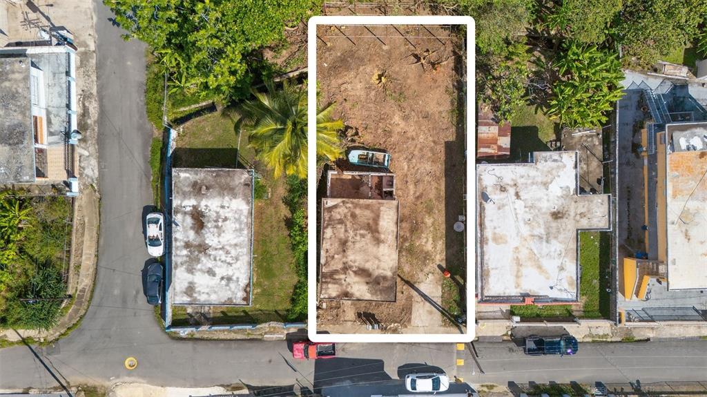 An aerial view shows a rectangular residential lot with a small structure and cleared land — COMM. HUCARES 119, NAGUABO, PR