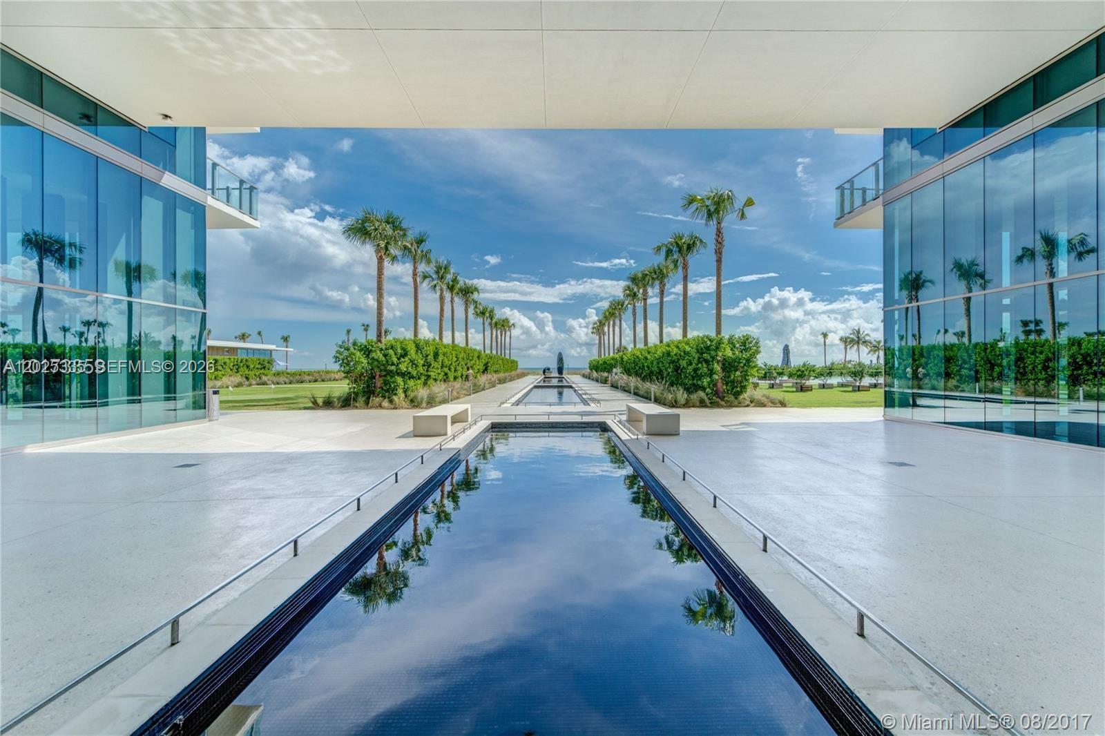 A long reflecting pool sits between two glass buildings under a large covered walkway — 350 OCEAN DR # 304N, Key Biscayne FL 33149, KEY BISCAYNE, FL