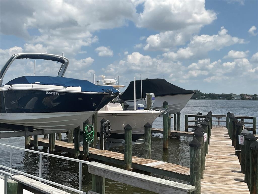 Three boats are docked at a wooden pier on a sunny day — 0 SHARSWOOD LANE, SARASOTA, FL
