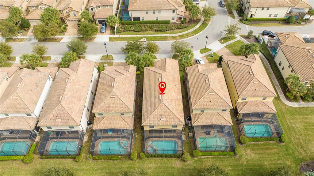 An aerial view shows a row of suburban houses with tile roofs and screened-in pools — 9013 RHODES STREET, KISSIMMEE, FL