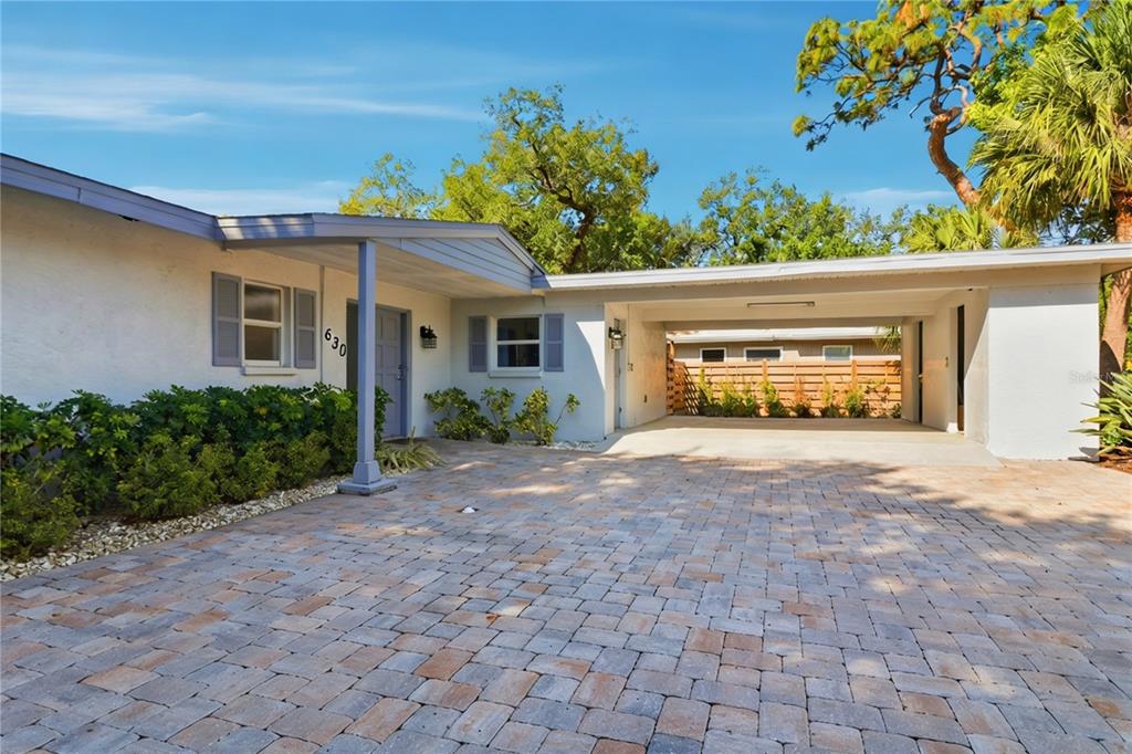 A single-story house features a paved driveway, a covered carport, and a front entryway — 630 CORWOOD DRIVE, SARASOTA, FL