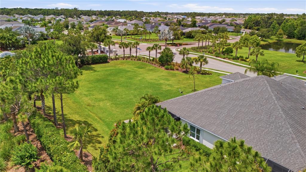 An aerial view shows a residential lot with a house, lawn, and surrounding neighborhood streets — 4504 DEEP CREEK TERRACE, PARRISH, FL