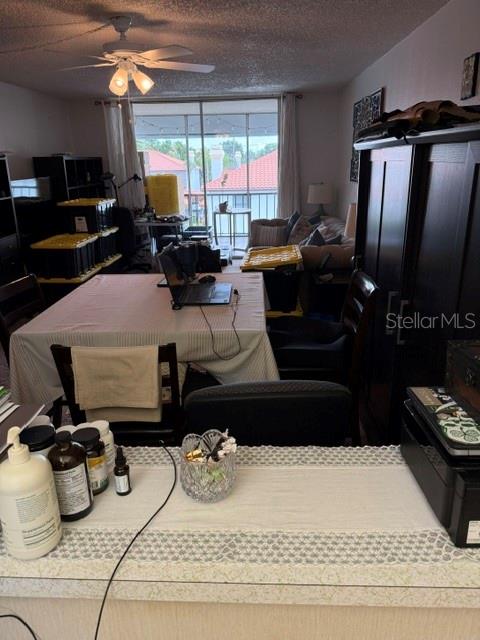 A dining area with a table, chairs, and a view of a balcony through sliding doors — 10530 77TH TERRACE UNIT 323, SEMINOLE, FL