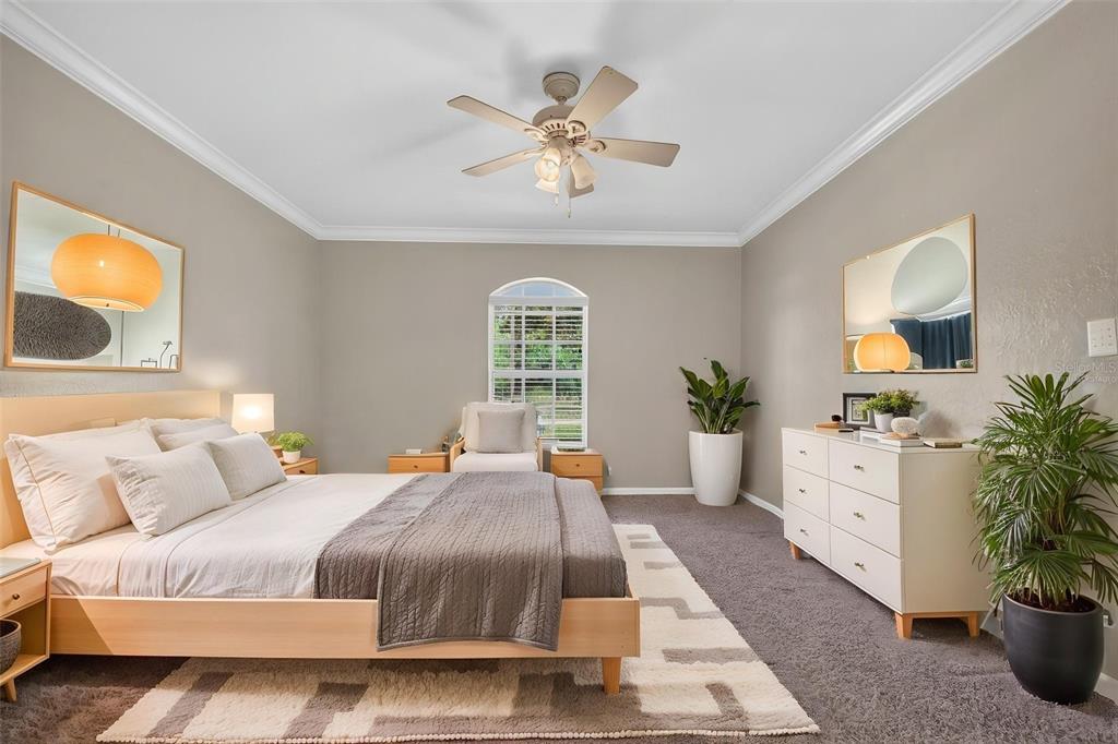 A bedroom features a light wood bed, a white dresser, two mirrors, and a ceiling fan — 2820 LIVINGSTON ROAD, AVON PARK, FL