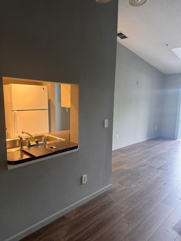 A view from a living area looking through a kitchen pass-through window — 1132 S PINE RIDGE CIRCLE UNIT 32, SANFORD, FL
