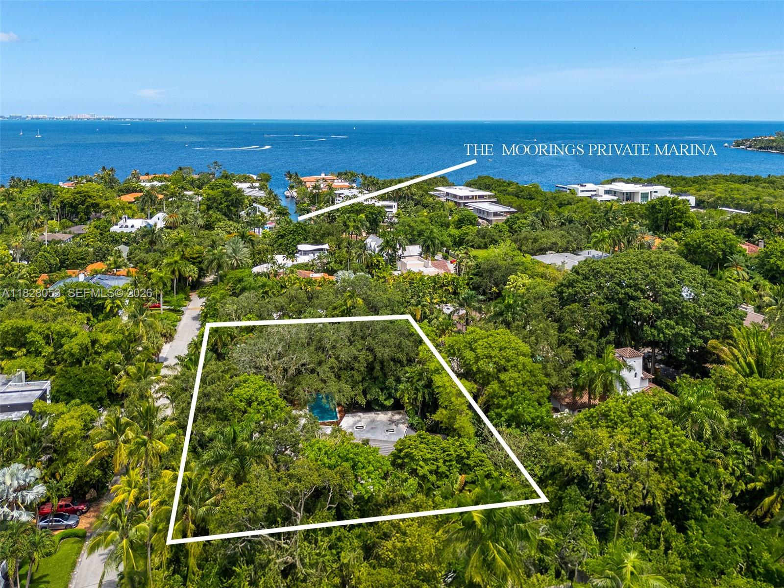 An aerial view shows a wooded residential lot with a swimming pool and house — 3540 N Moorings Way, Miami FL 33133, MIAMI, FL