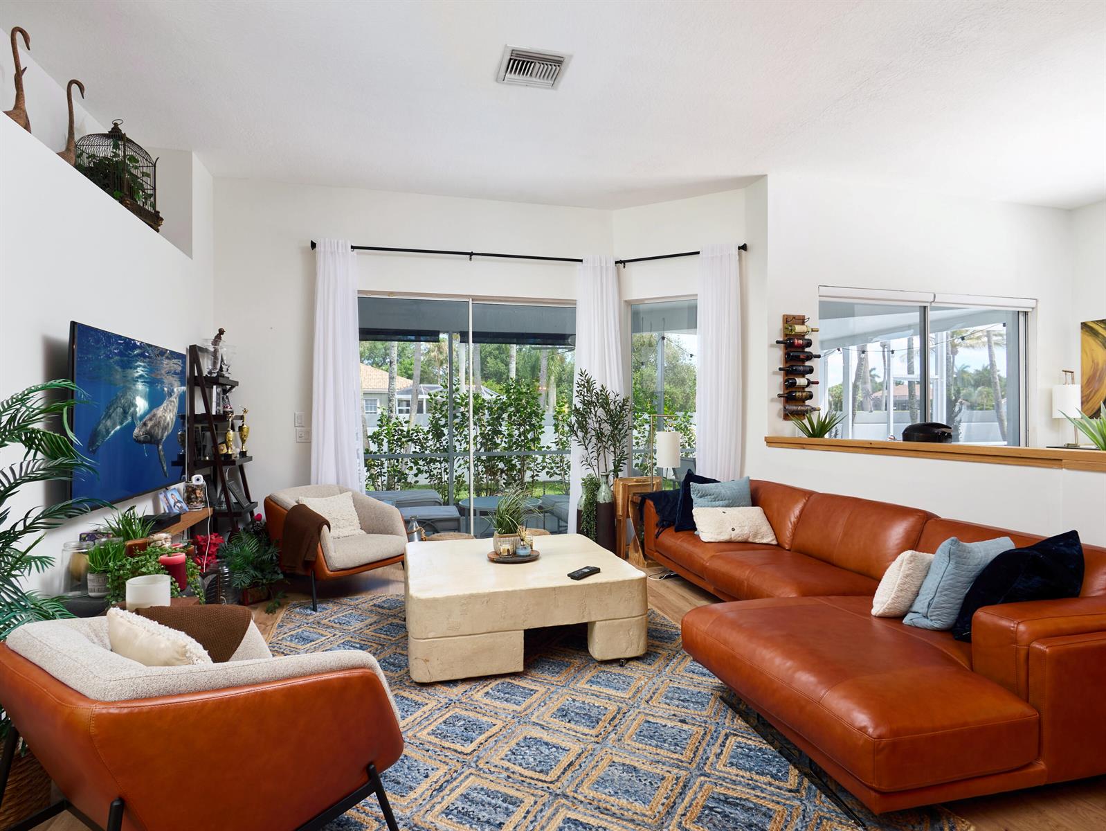 A living room features a leather sectional, two armchairs, a stone coffee table, and patio access — 8166 Quail Meadow Way, West Palm Beach FL 33412, WEST PALM BEACH, FL