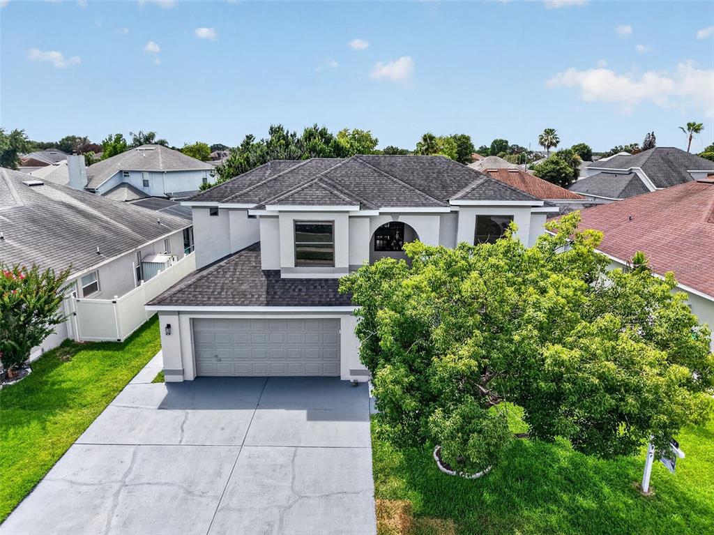 An aerial view of a two-story house with a gray shingle roof and garage — 12441 BOHANNON BOULEVARD, ORLANDO, FL
