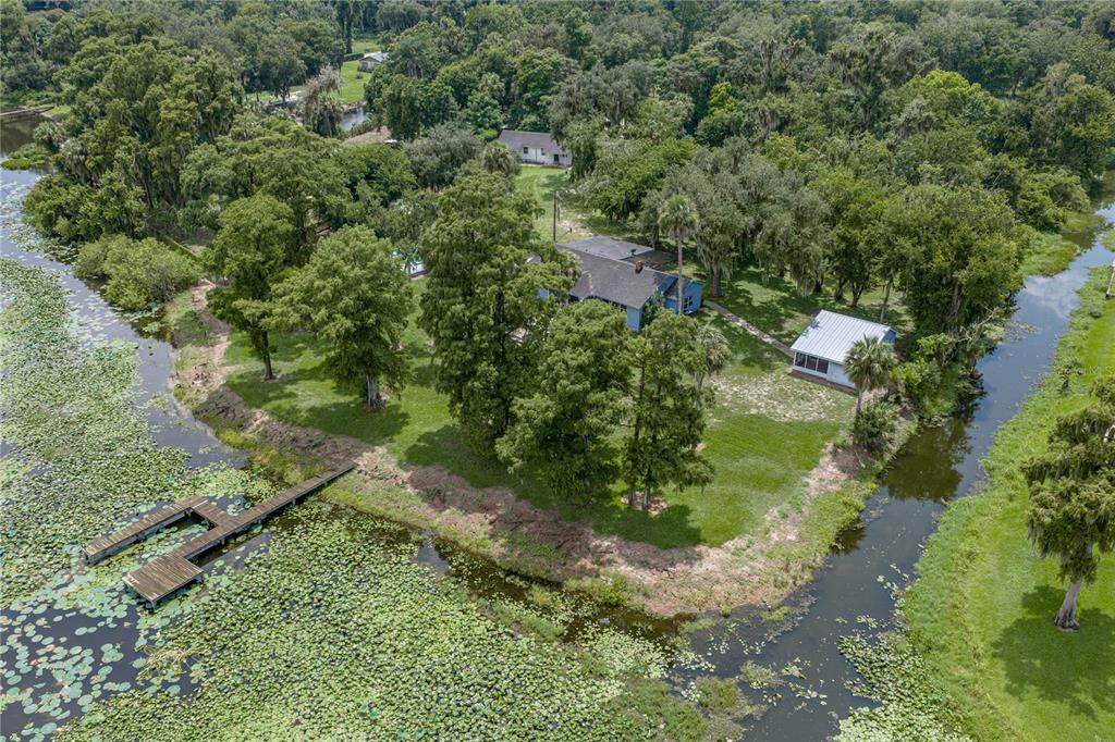 An aerial view shows a house and detached garage situated on a grassy waterfront lot — 2901 KAYWORTH ROAD, LAKE WALES, FL