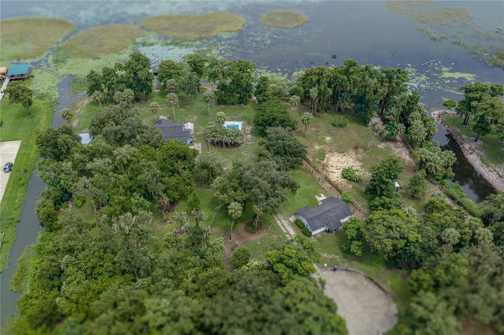 An aerial view shows two houses on a large, tree-filled lot bordering a lake — 2901 KAYWORTH ROAD, LAKE WALES, FL