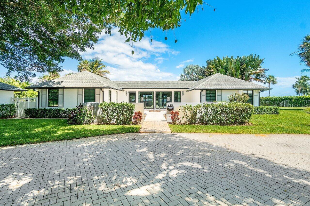 A single-story white house with a hip roof and a paved circular driveway — 210 S Lake Drive, Lantana FL 33462, LANTANA, FL