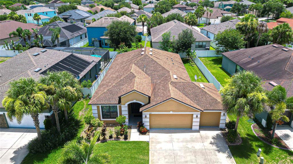 An aerial view shows a single-story suburban house with a brown roof and garage — 8443 WHITE POPLAR DRIVE, RIVERVIEW, FL