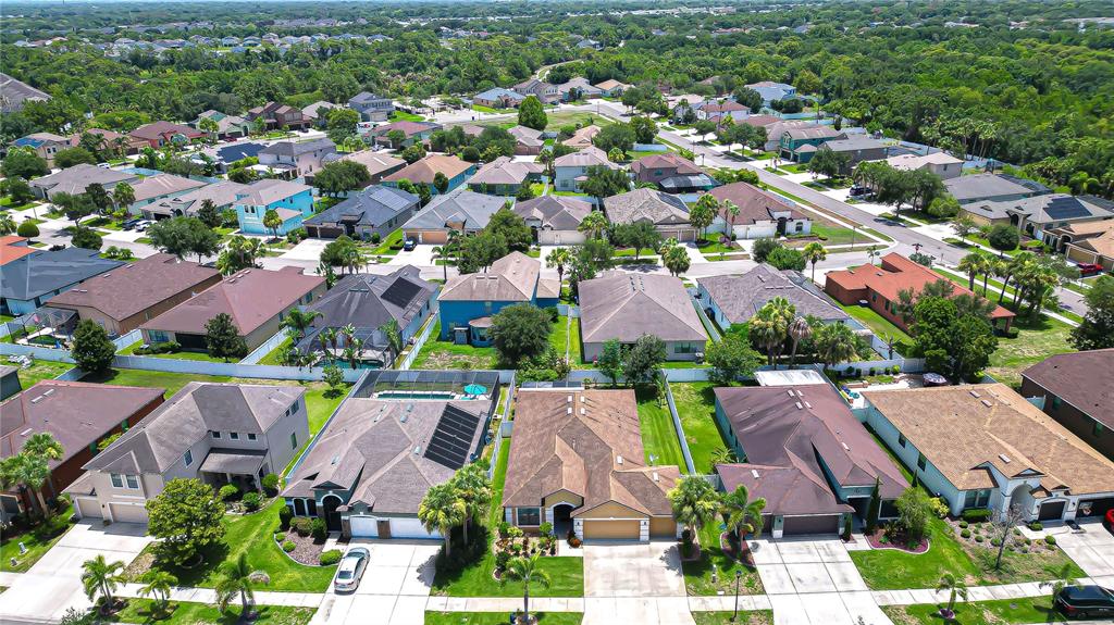 An aerial view shows a single-story suburban house with a brown roof and garage — 8443 WHITE POPLAR DRIVE, RIVERVIEW, FL