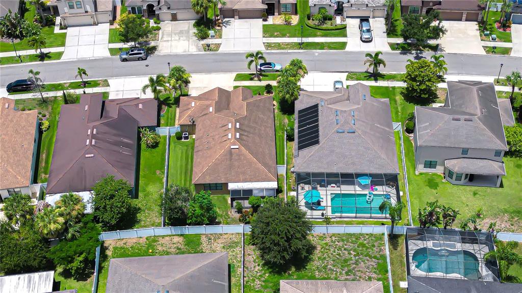 An aerial view shows a suburban neighborhood with single-family homes, green lawns, and paved streets — 8443 WHITE POPLAR DRIVE, RIVERVIEW, FL