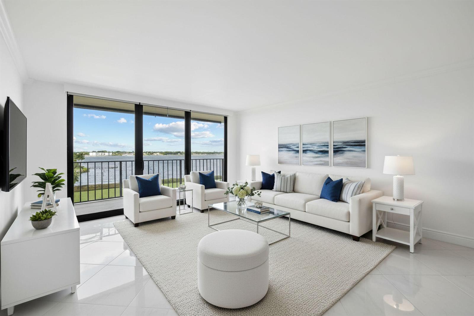 A bright living room features white furniture, a glass coffee table, and a balcony view — 3460 S Ocean Boulevard # 510, Palm Beach FL 33480, PALM BEACH, FL