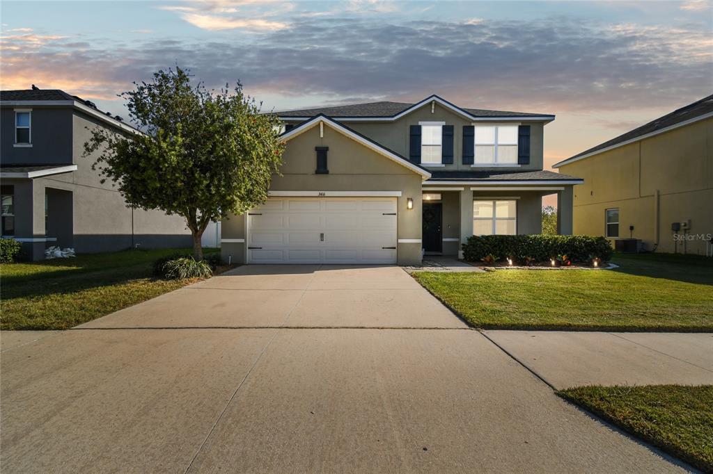 A two-story suburban house with a two-car garage, a concrete driveway, and a front lawn — 3416 SAN MOISE PLACE, PLANT CITY, FL