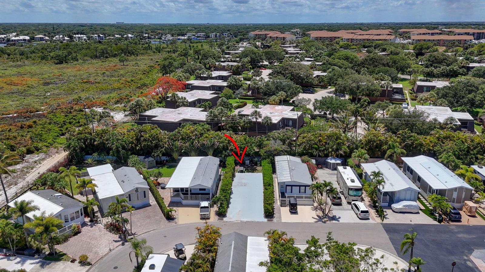 An aerial view shows a vacant concrete lot situated between two manufactured homes — 900 Juno Ocean Walk, Juno Beach FL 33408, JUNO BEACH, FL