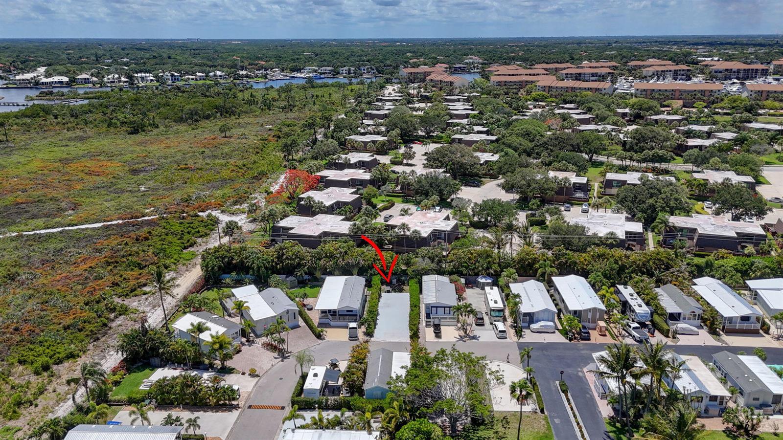 An aerial view of a residential neighborhood featuring manufactured homes and a nearby nature preserve — 900 Juno Ocean Walk, Juno Beach FL 33408, JUNO BEACH, FL