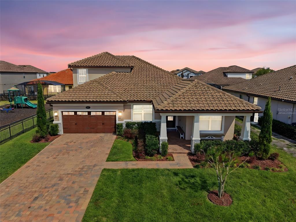 An aerial view shows a single-family home with a tiled roof, garage, and paved driveway — 251 TEDDY RUSHING STREET, DEBARY, FL