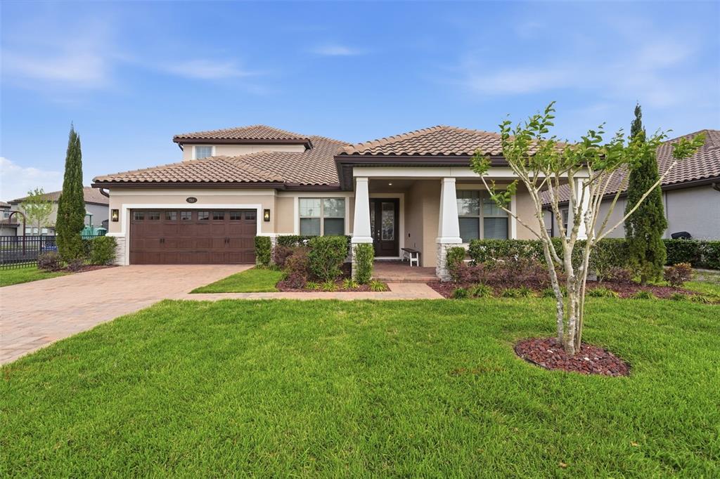 A single-story house with a brown tile roof, a two-car garage, and a front porch — 251 TEDDY RUSHING STREET, DEBARY, FL