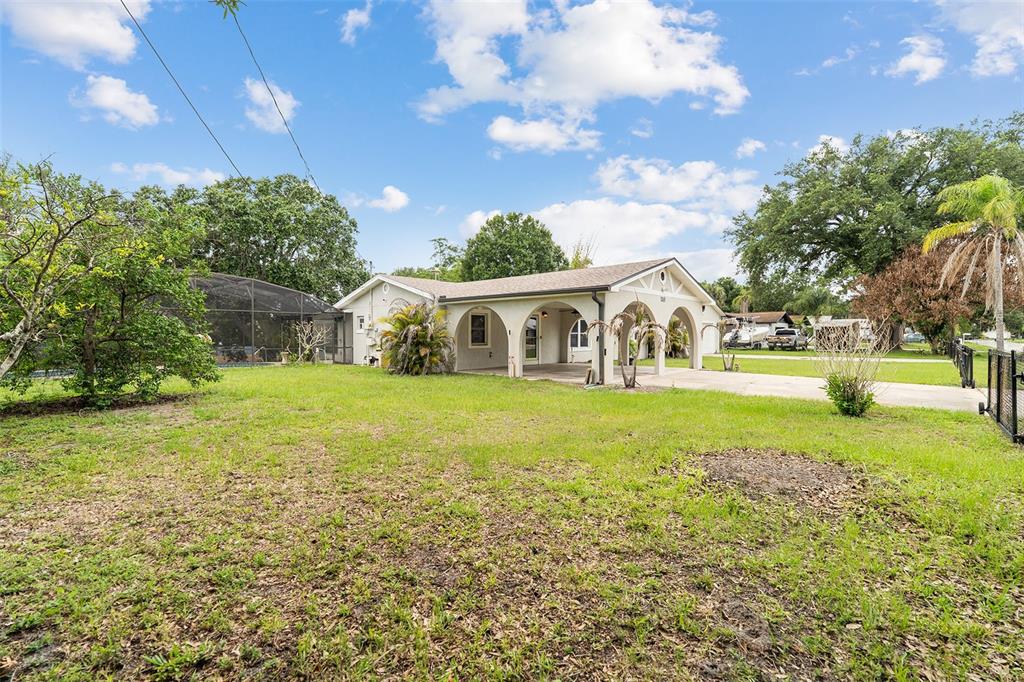 A single-story house with a covered arched porch sits on a grassy lot — 110 EDGEWATER DR, ST CLOUD, FL