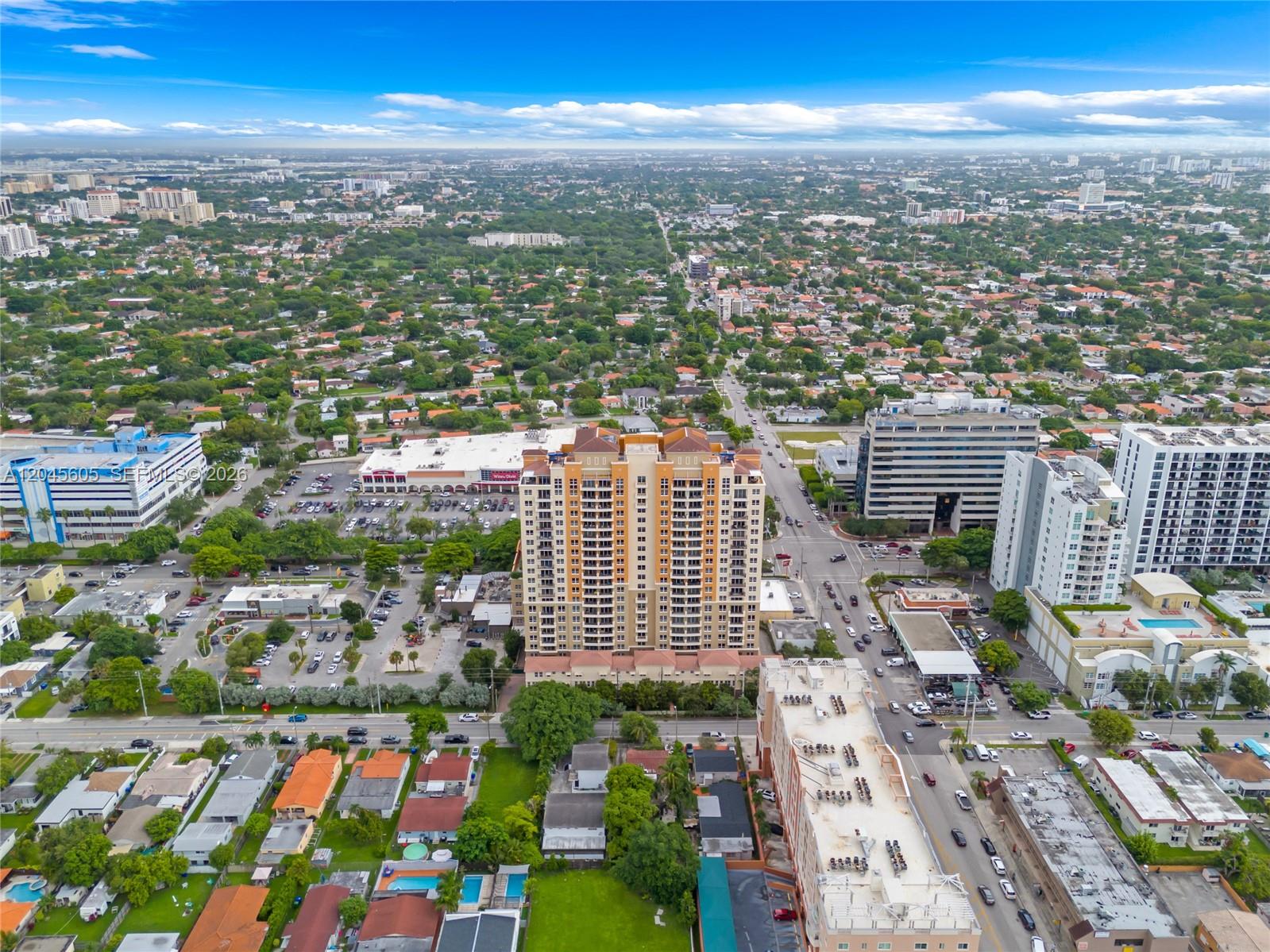 An aerial view shows a tall residential building surrounded by suburban streets and commercial properties — 3232 SW 22nd Ter # 804, Miami FL 33145, MIAMI, FL