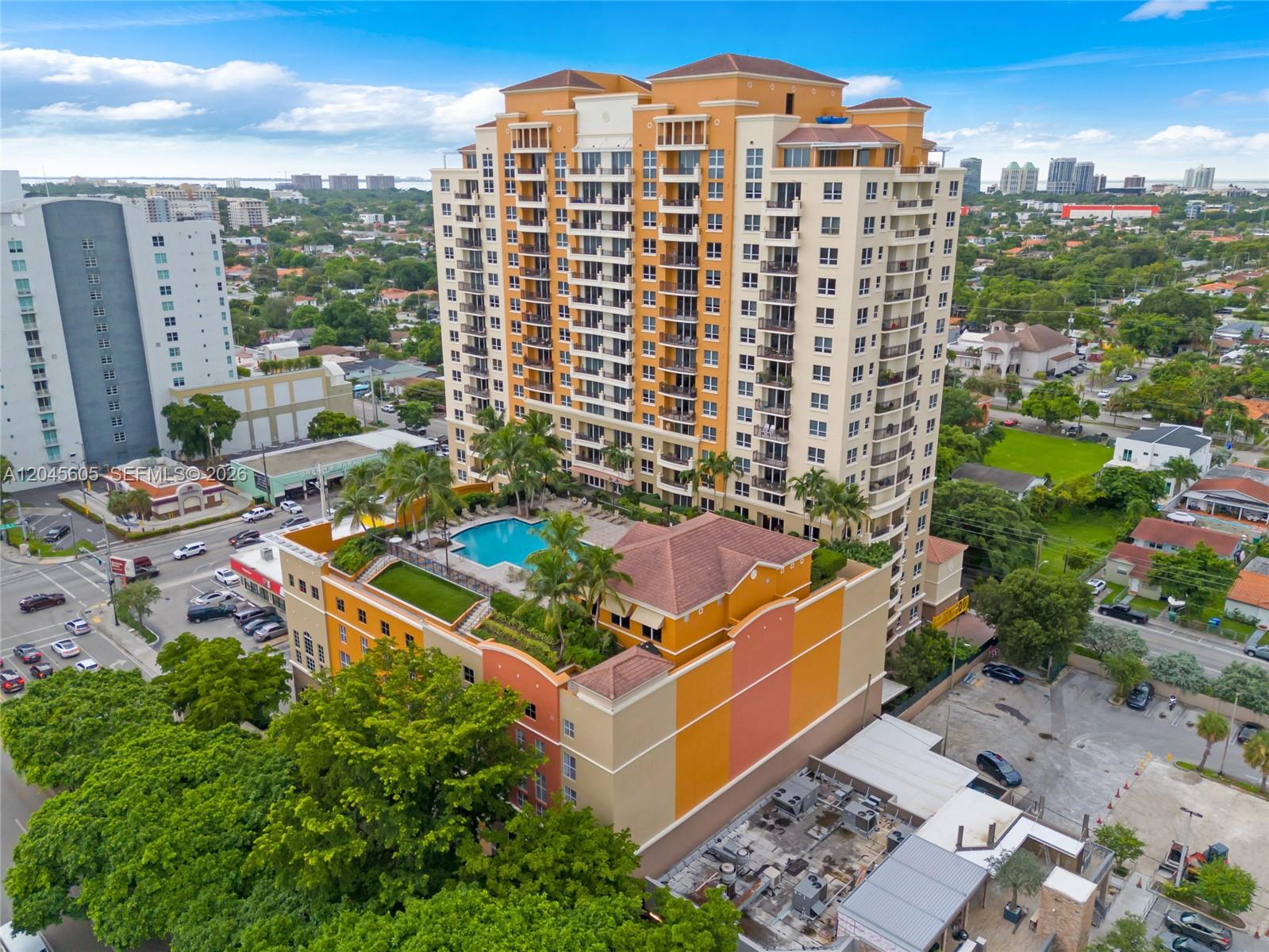 An aerial view shows a tall, multi-story apartment building with an outdoor pool deck — 3232 SW 22nd Ter # 804, Miami FL 33145, MIAMI, FL