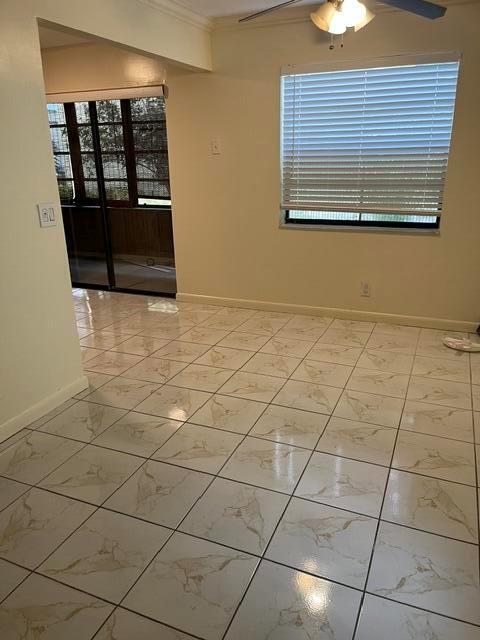 A room with light-colored tile flooring, a window with blinds, and a sliding glass door — 207 Capri E # 207, Delray Beach FL 33484, DELRAY BEACH, FL