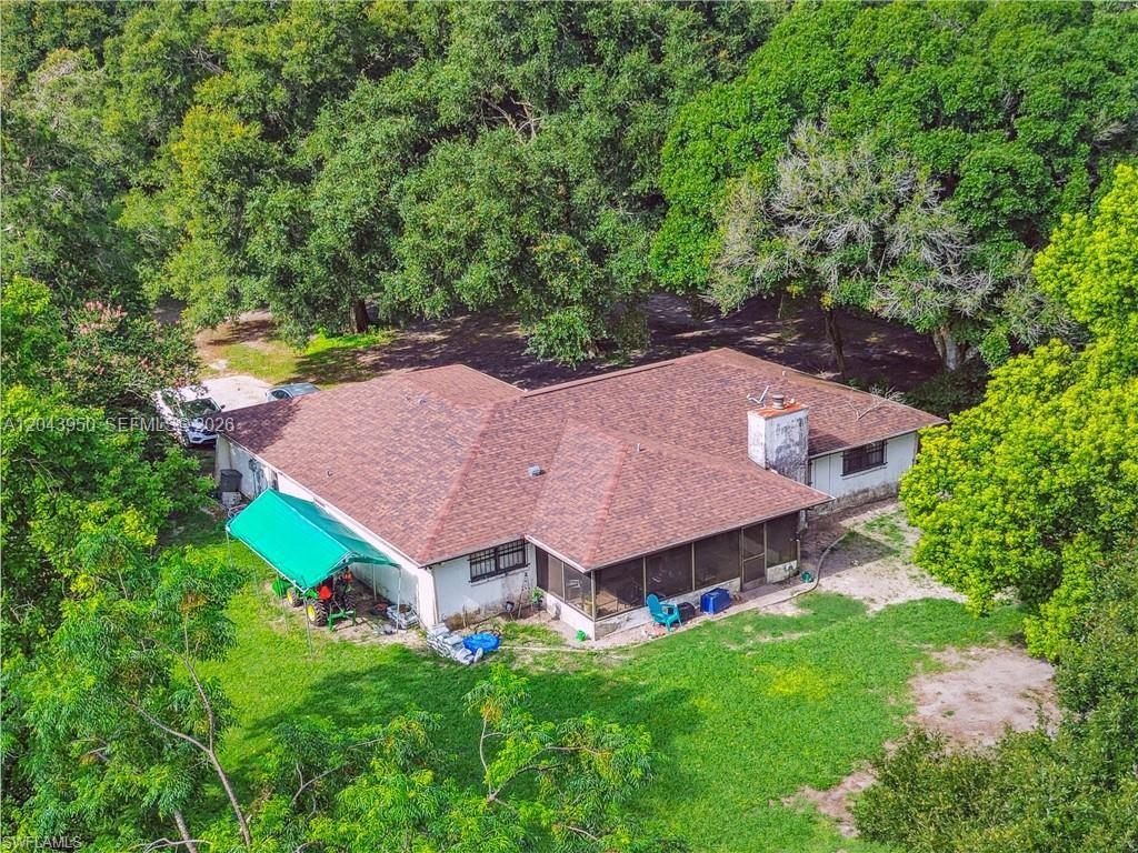 An aerial view shows a single-story house with a brown shingled roof and a screened porch — OTHER CITY - IN THE STATE OF FLORIDA, MS