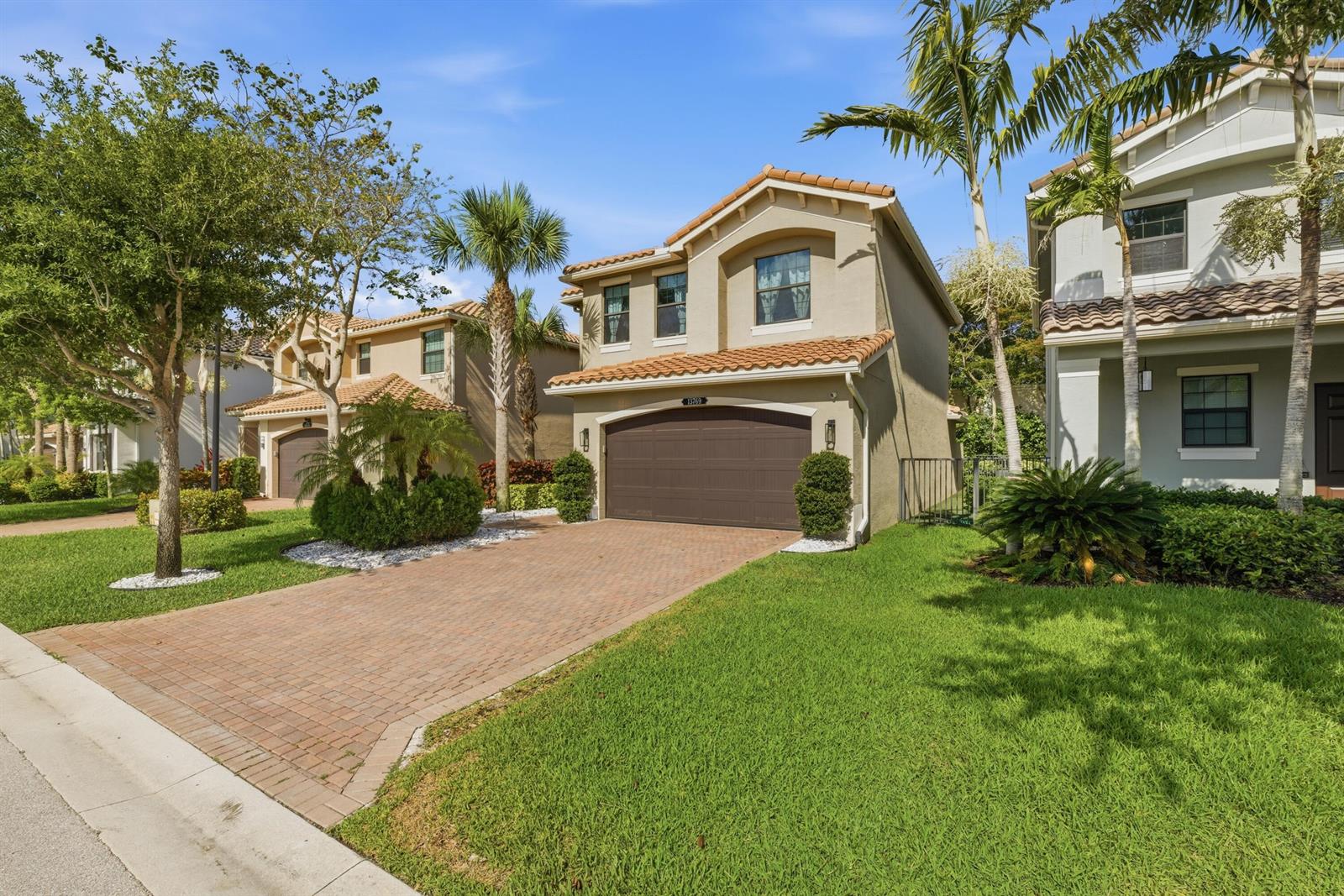 A two-story suburban house with a brown garage door and a brick paver driveway — 13769 Moss Agate Avenue, Delray Beach FL 33446, DELRAY BEACH, FL