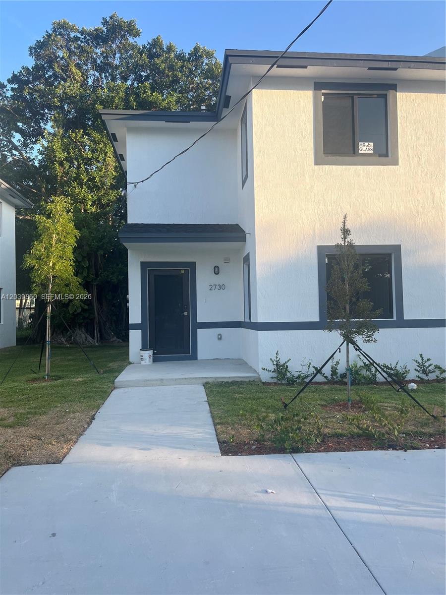 A two-story white house with gray trim and a front entrance walkway — 2730 NW 44th Steet # 3, Miami FL 33142, MIAMI, FL