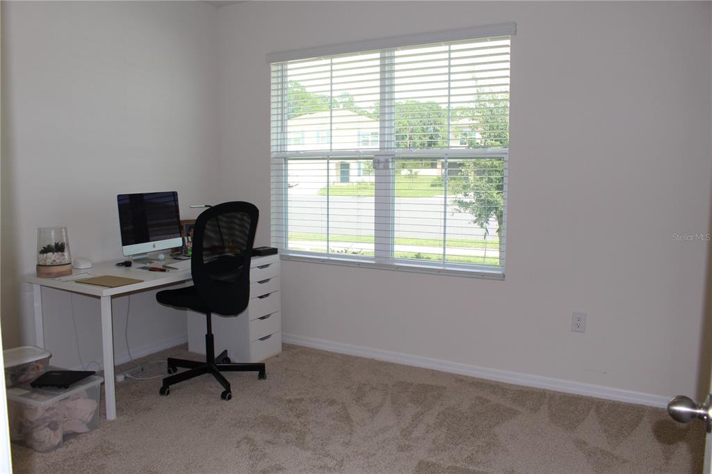 A home office features a desk, computer, chair, and a window with blinds — 2917 CANARY LANE, TAVARES, FL