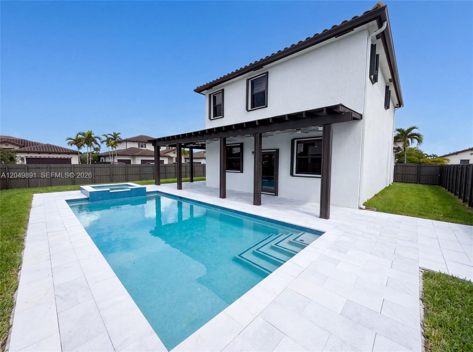 A two-story house with a white stucco exterior features a backyard pool and pergola — 12858 SW 228th St, Miami FL 33170, MIAMI, FL